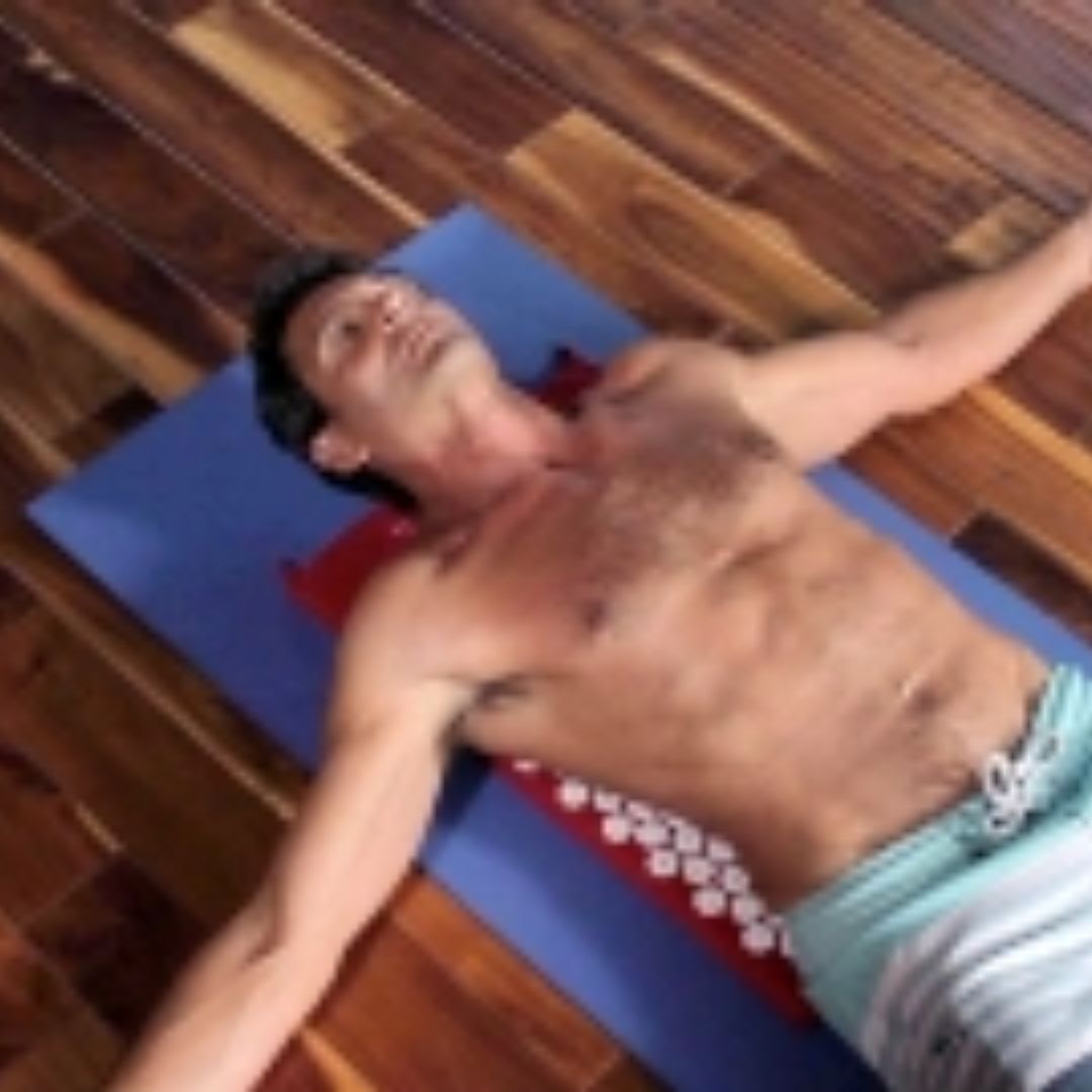 Man laying on acupressure mat