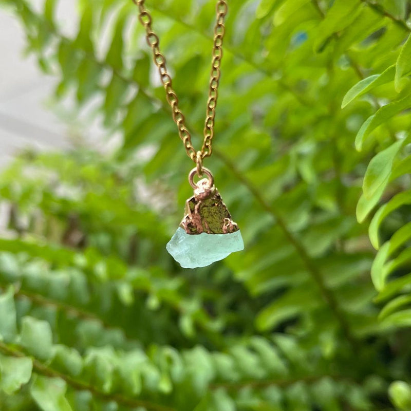 Clear green flourite stone pendant on gold chain