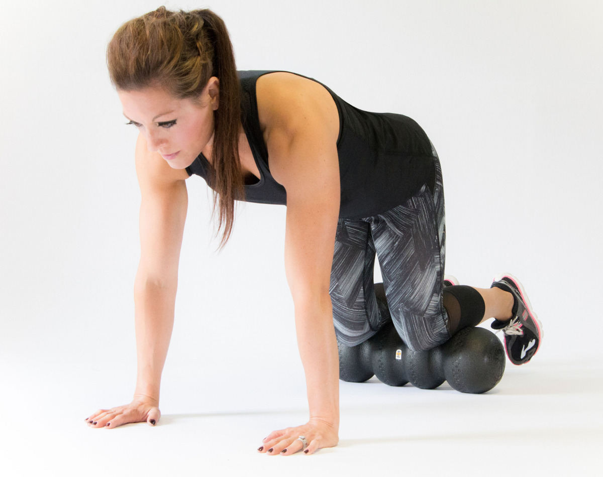 Woman rolling shins on foam roller