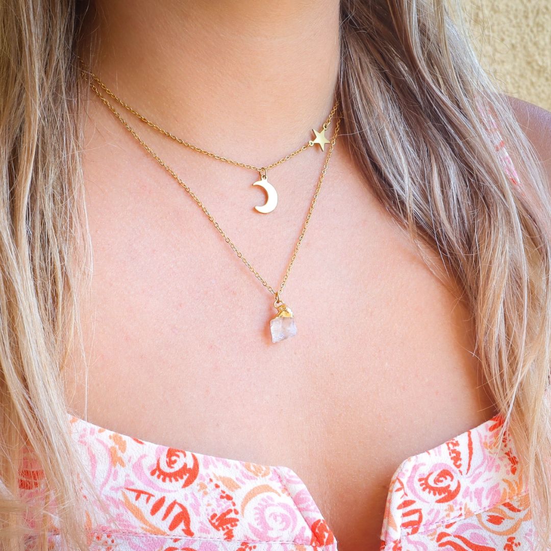 Raw stone pendant worn with gold star & moon pendant