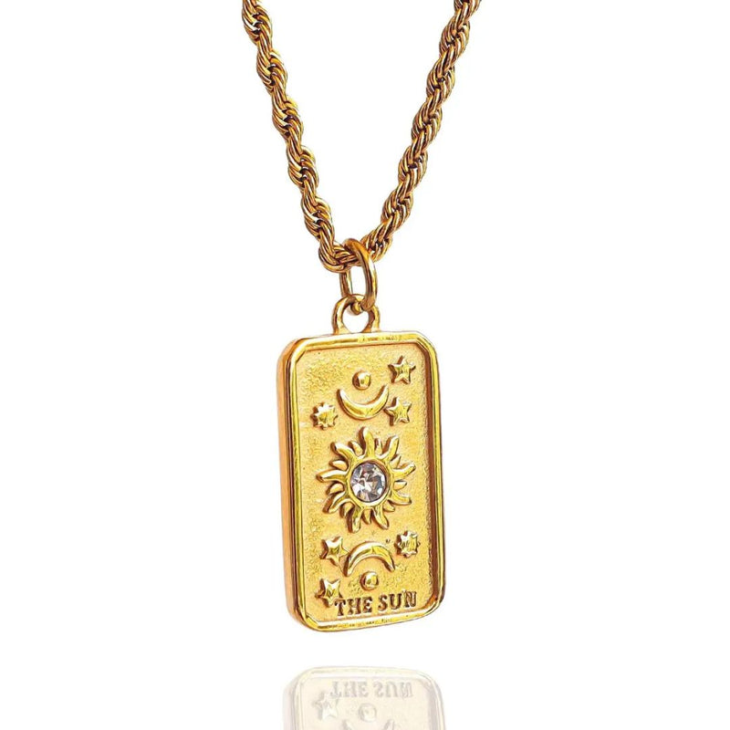 The Sun gold tarot card necklace. A clear crystal is in the center of the sun.