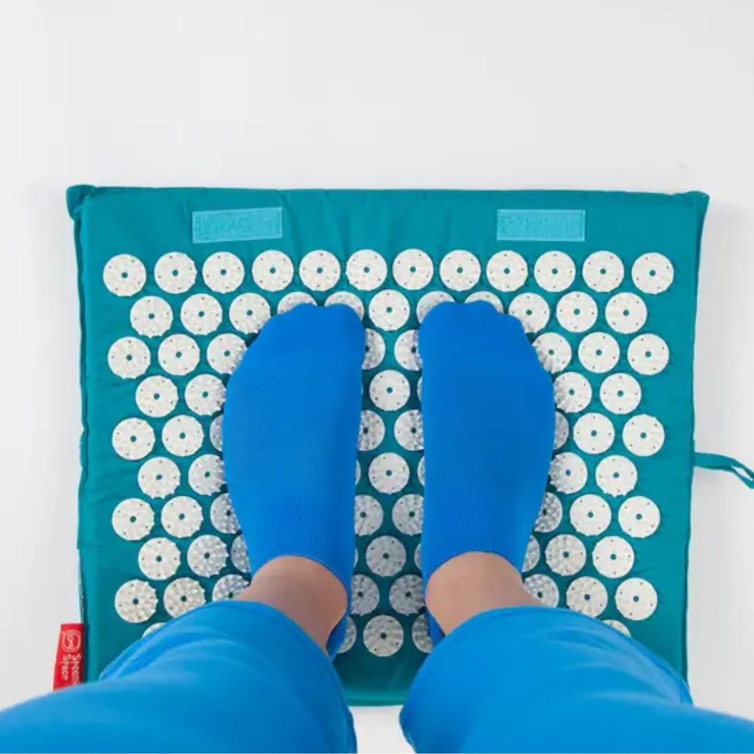 Standing on acupressure mat