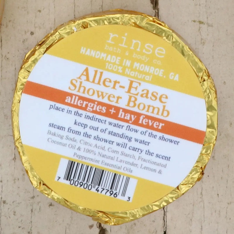 Aller-Ease Shower Bomb disk in gold wrapper