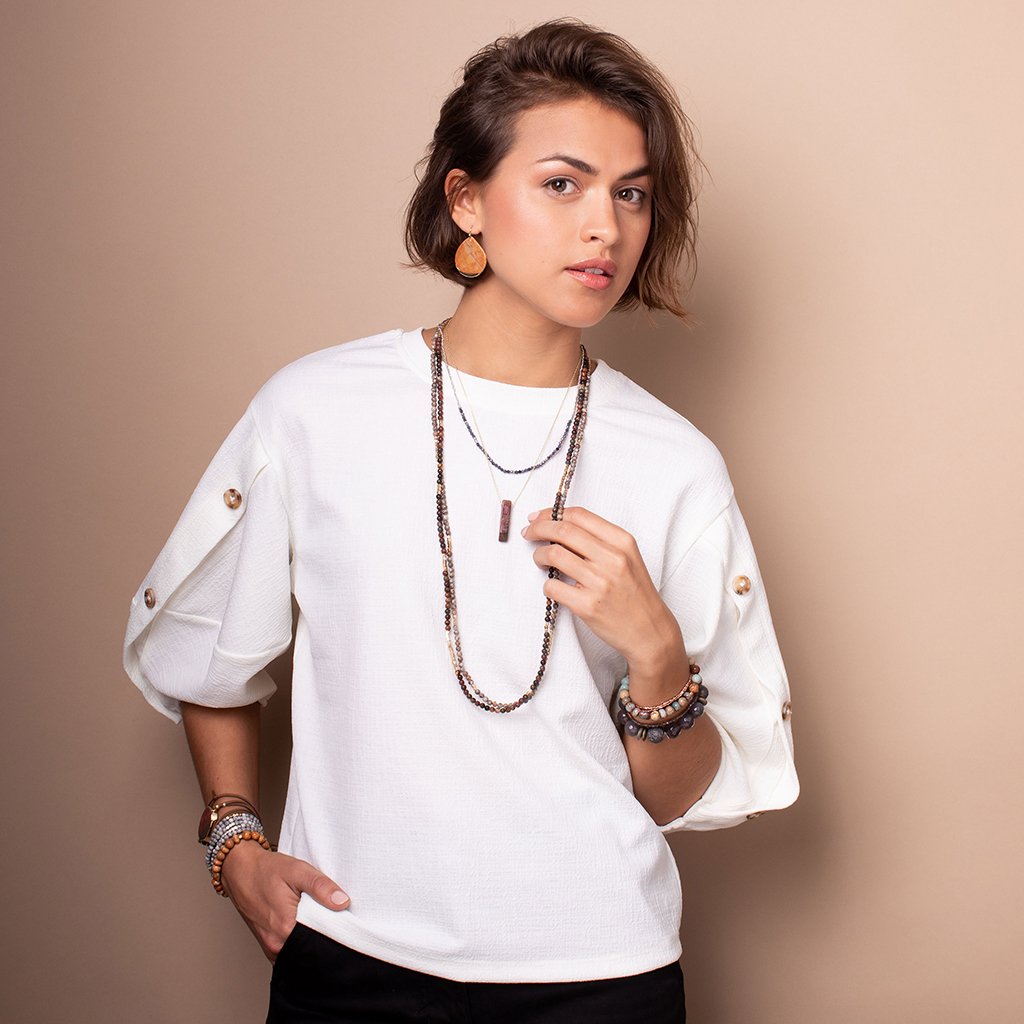 Model wearing stone duo wraps as necklaces