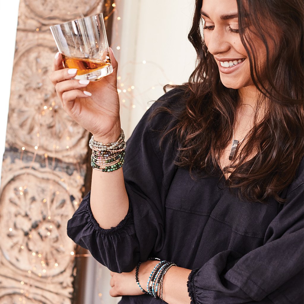 Model wearing stone duo wraps as bracelets and a coordinating stone necklace.
