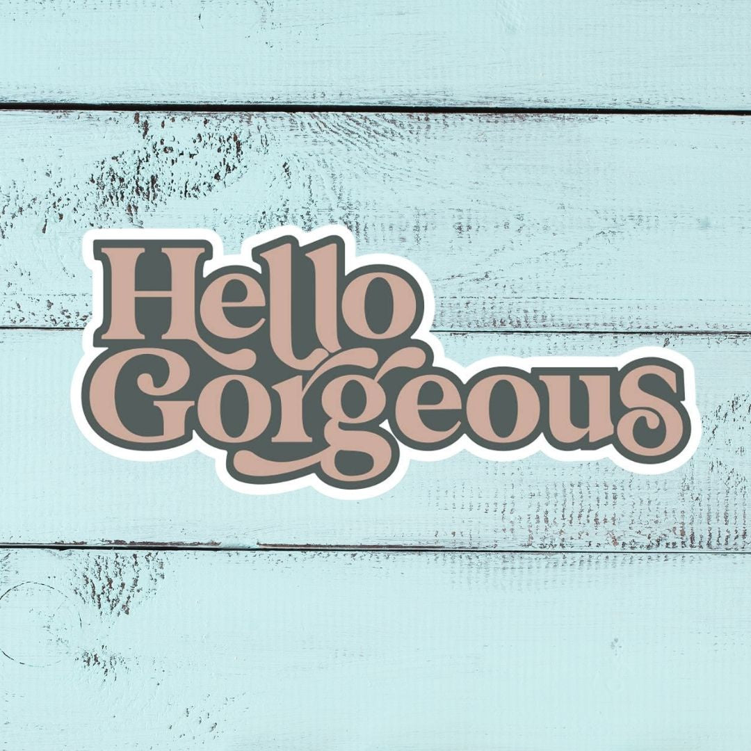 Hello Gorgeous sticker on blue wood background