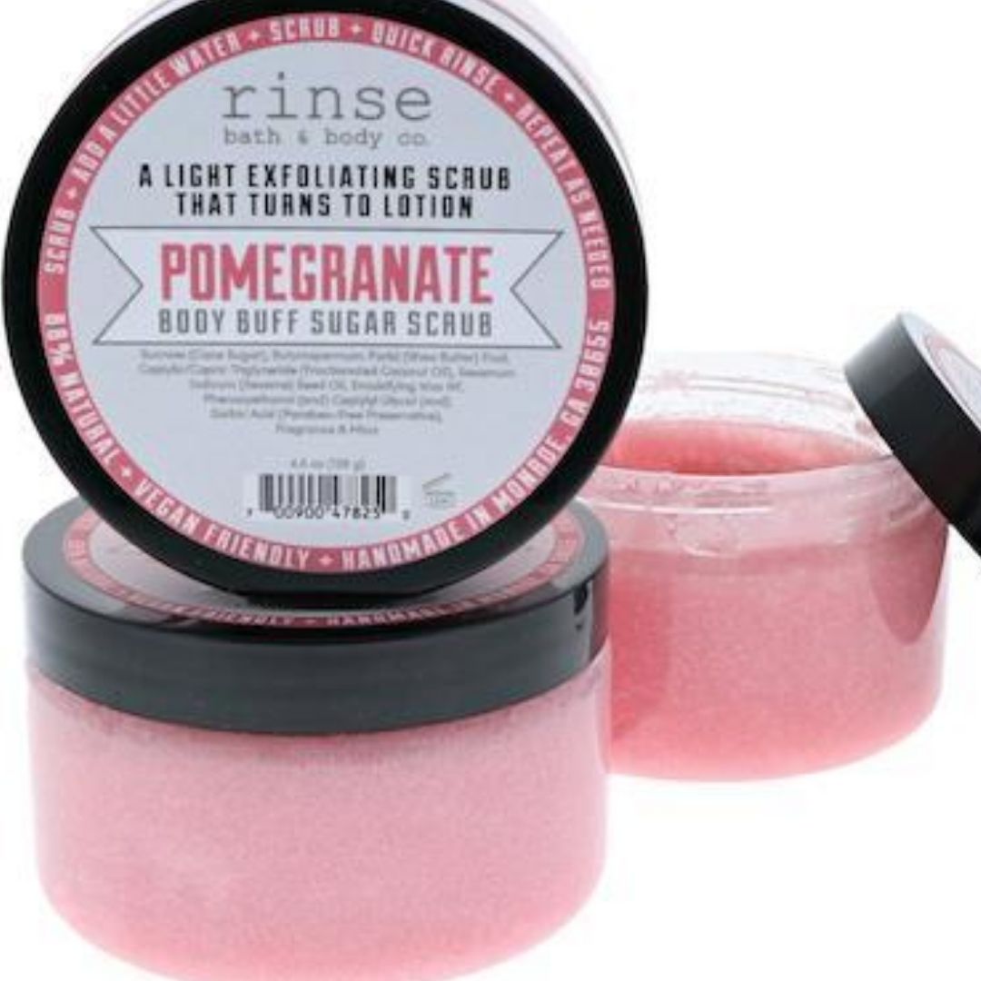 Open jar of pomegranate body scrub with a slushie like consistency