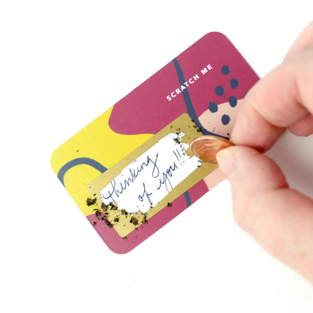Yellow, pink, and blue note card with scratch off message revealed