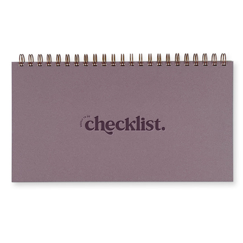 A Wisteria purple colored planner with "weekly to do checklist" written in dark purple on the cover. There is a spiral binding along the top of the planner.