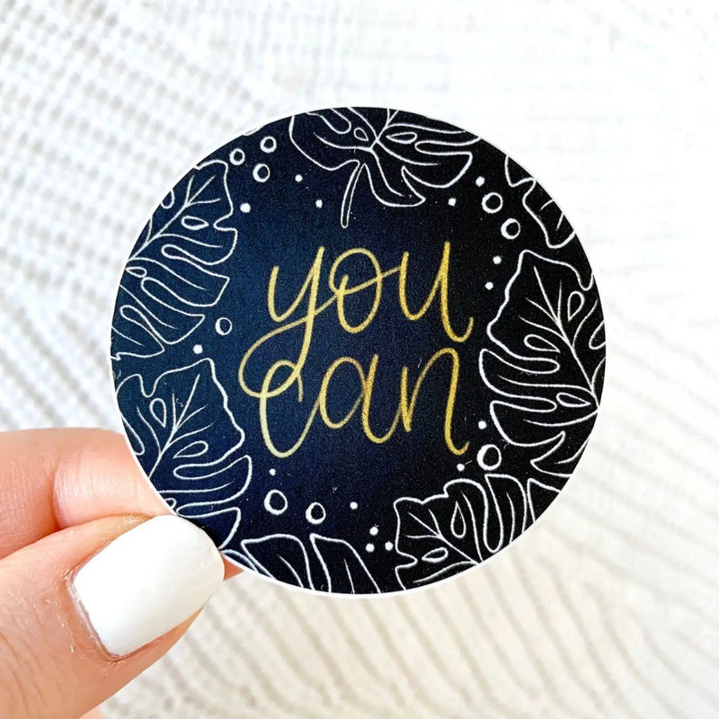 Round black sticker with monstera print. "you can" written in gold. Elyse Breanne Designs