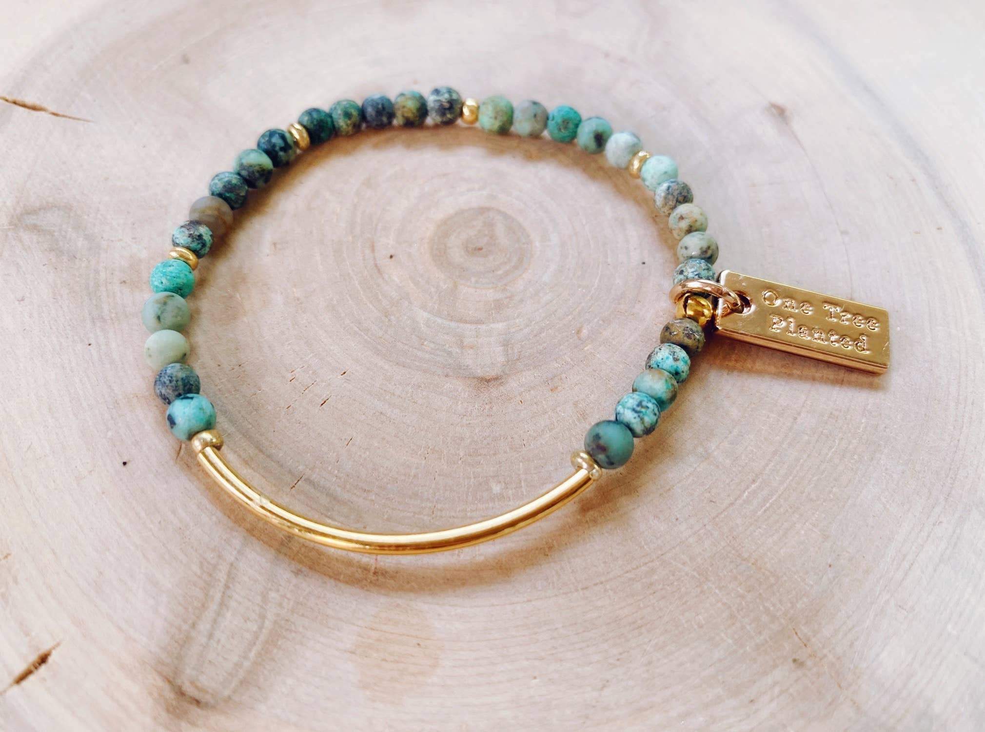 Bracelet with greenish tinted African Turquoise beads and a section of gold band.