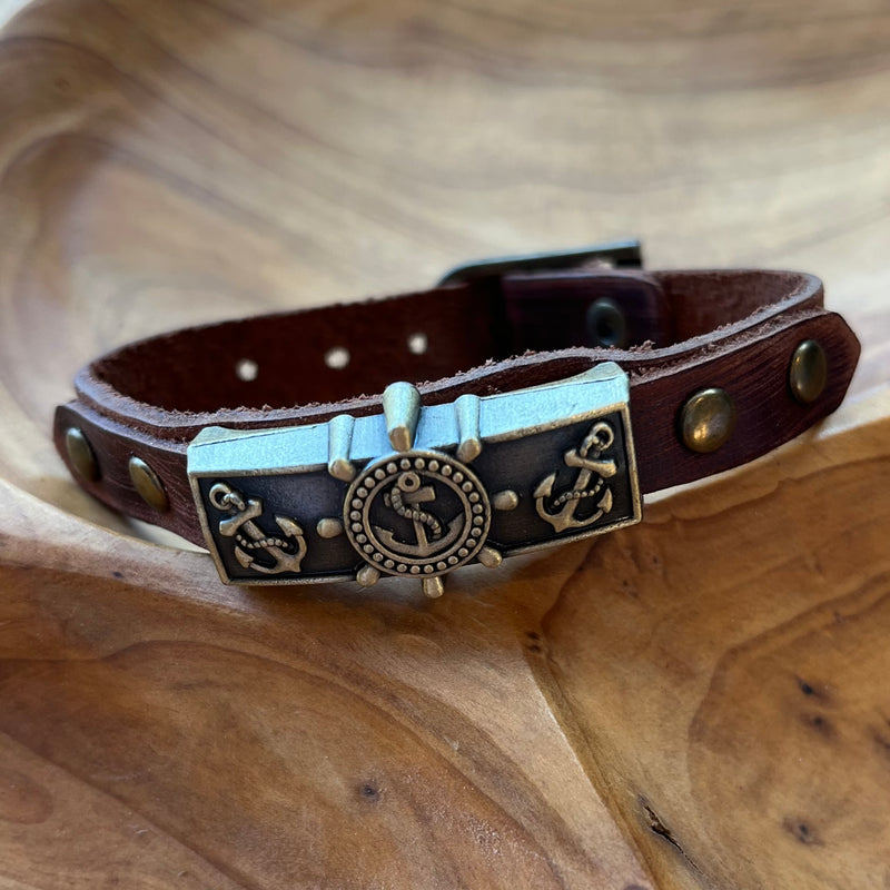 Dark brown leather cuff with brass plate with anchors on it