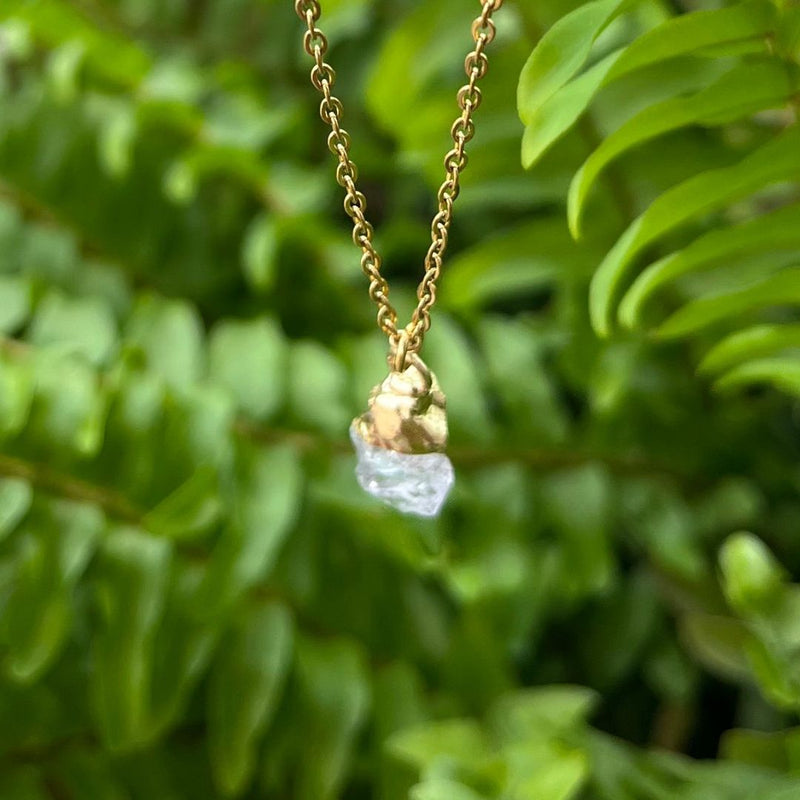 Clear crystal quartz pendant on a gold chain