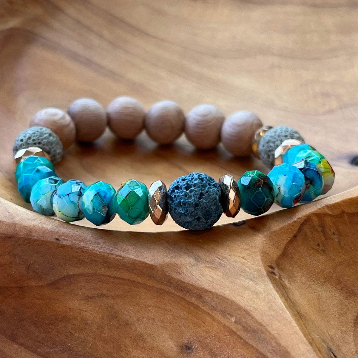 Brown rosewood beads and turquoise ocean colored beaded bracelet. Three lava rock beads for essential oils.
