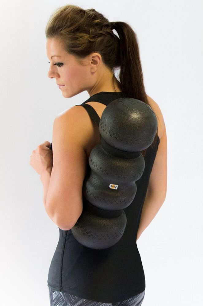 Woman carrying foam roller with carrying strap