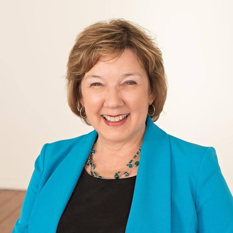 Photo of woman with brown hair wearing blue blazer