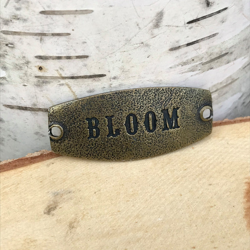 antique brass Lenny & Eva bracelet that says bloom 