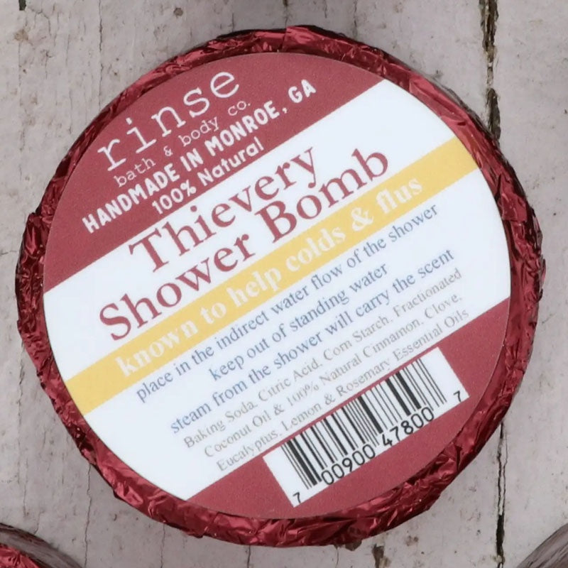 Thievery Shower Bomb disk in dark red foil wrapper