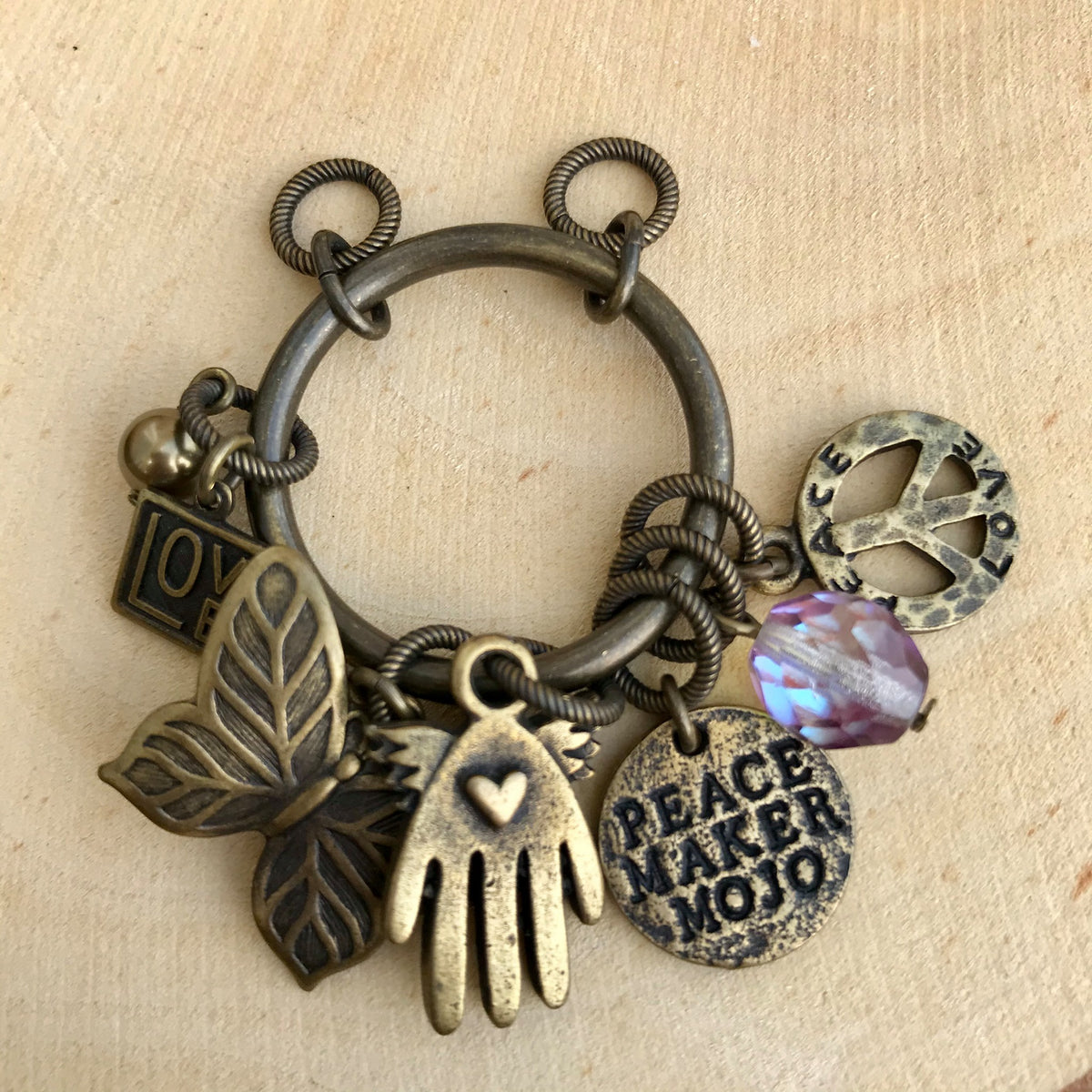 Antique brass Peace Maker Mojo pendant with LOVE, butterfly, hand, peace sign, and colored bead charms