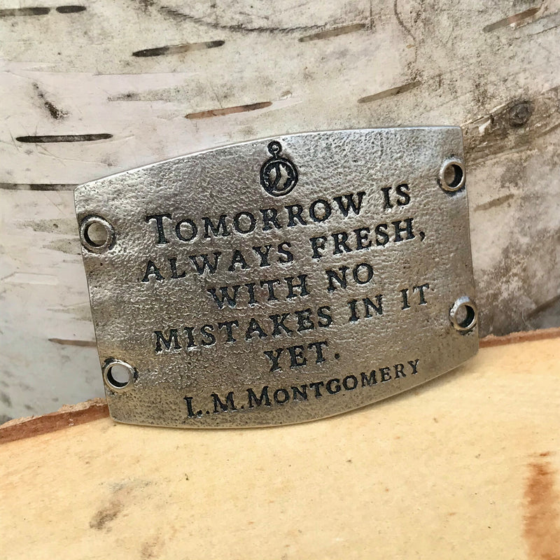 Antique silver finish Lenny & Eva bracelet sentiment that reads, "Tomorrow is always fresh, with no mistakes in it yet." Quote by L.M. Montgomery. A clock is etched above the quote.