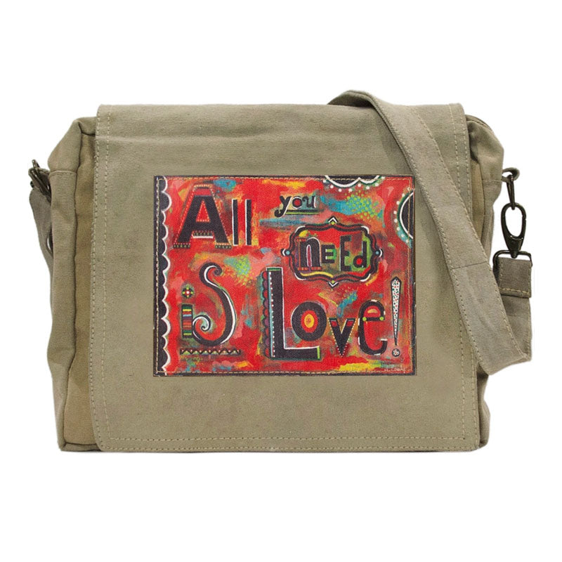 Tan or olive (colors vary) crossbody bag made of recycled military tents. This bag features a large colorful patch on the flap that reads "All you need is Love!" Patch has a red background with patterns in blues, greens, yellows, black and white.