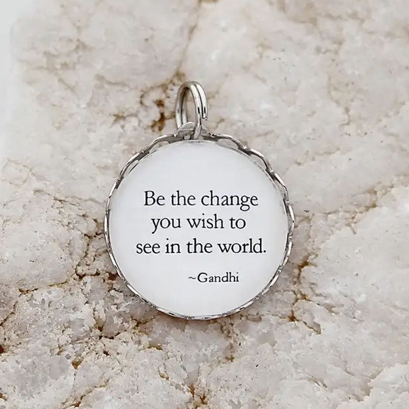 Necklace pendant that says, "Be the change you wish to see in the world. ~Gandhi"