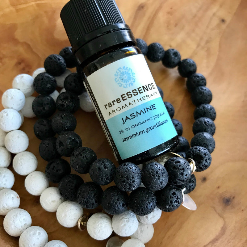 Stack of Lava Rock Essential Oil Aromatherapy Diffuser Bracelets by Lotus Jewelry Studio. Pictured with Jasmine Essential Oil by rareESSENCE.