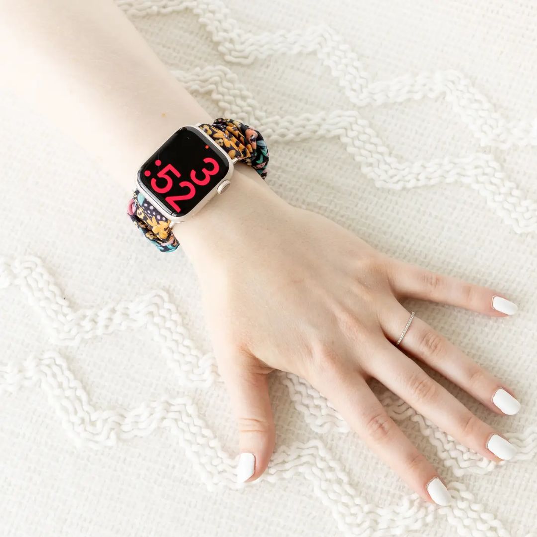 Apple watch with black floral band on wrist