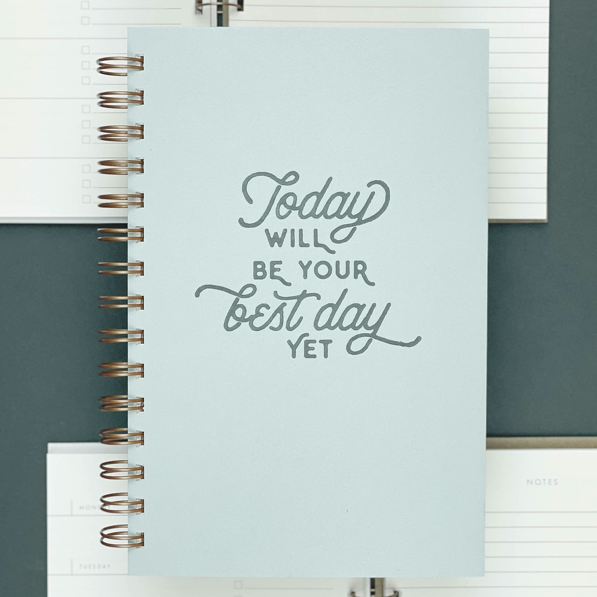 Light blue hardcover spiral bound journal planner titled "Today will be your best day yet"