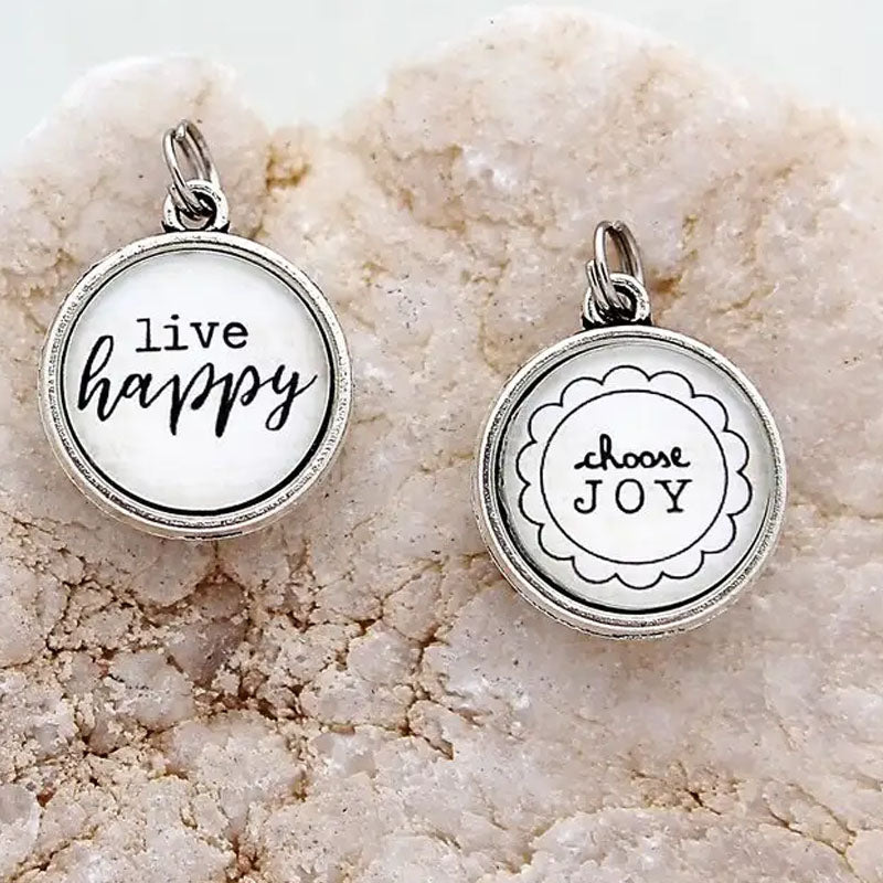 Necklace pendant that says "live happy" on one side and "choose joy" on the other side.