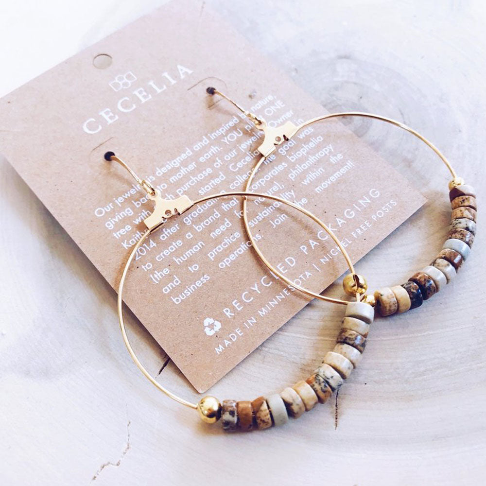 Gold earrings with small heishi (disc shaped) picture jasper beads in shades of brown and tan on a gold hoop