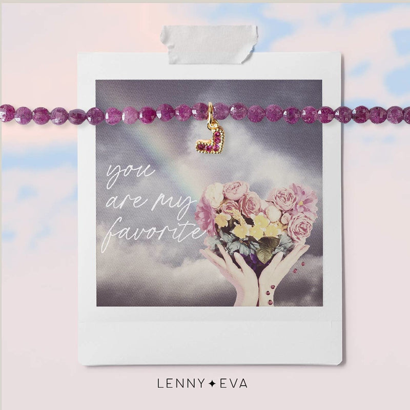 Delicate ruby beaded stretchy bracelet with tiny gold heart with ruby stones. Packaged on card with a heart bouquet of flowers and text that reads "you are my favorite"