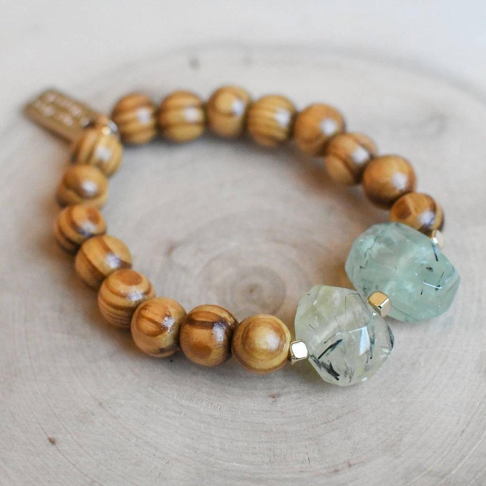 Stretchy bracelet with round wood beads and two large organic shaped green gemstones as focal beads