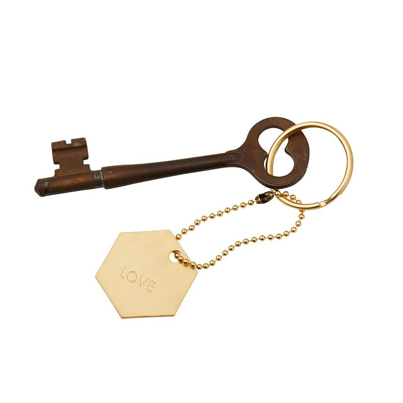 Hexagonal gold intention sentiment attached to keychain