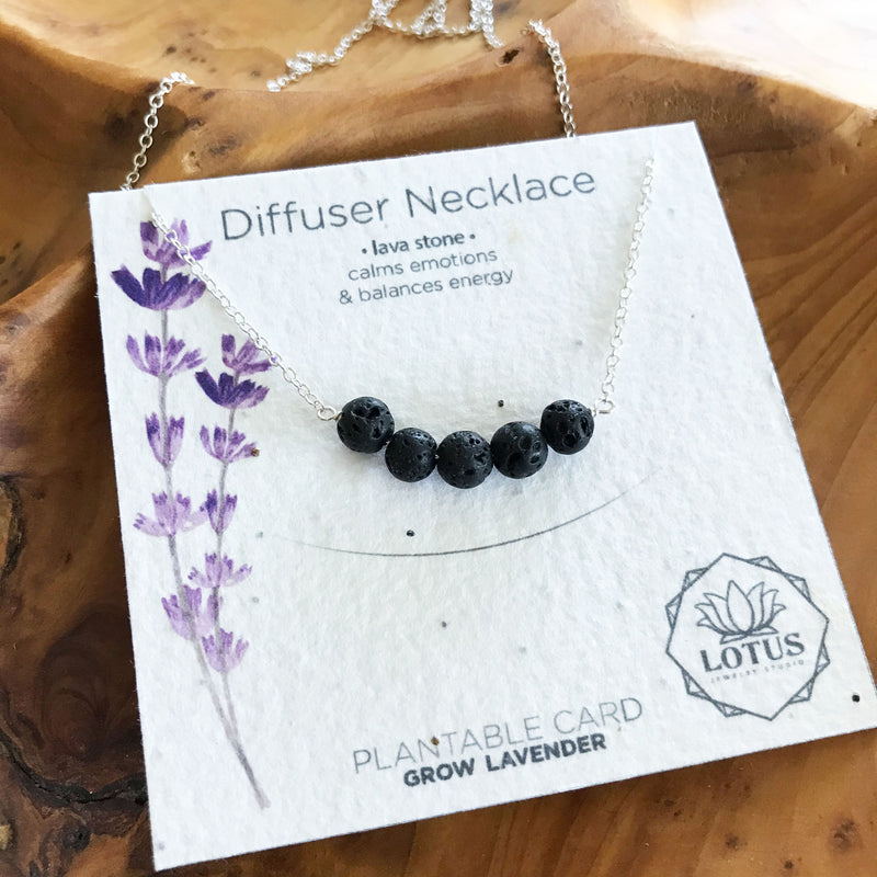 A sterling silver necklace with a bar of black lava rocks to use for essential oil aromatherapy. Made in the U.S.A. by Lotus Jewelry Studio.