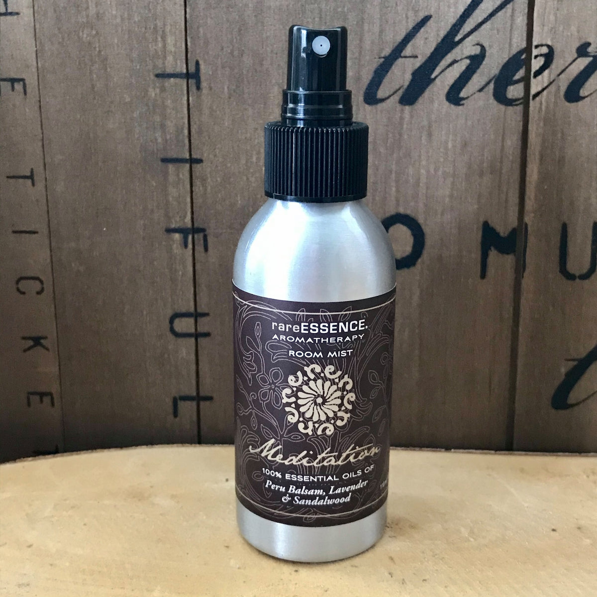 Spray bottle of Meditation room mist labeled made of balsam, lavender, and sandalwood essential oils.