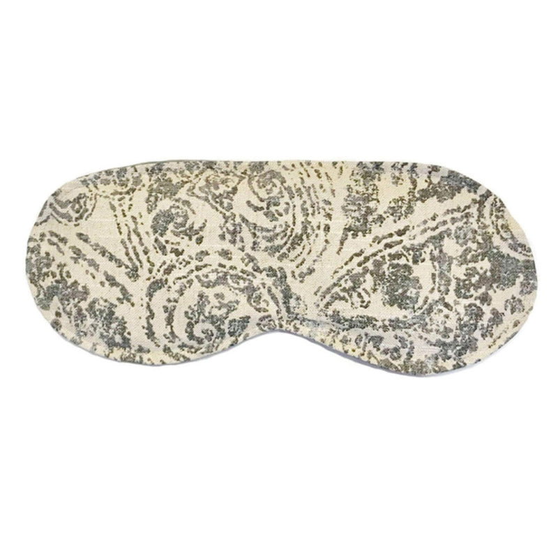Eye mask with an ivory colored background and grey damask print