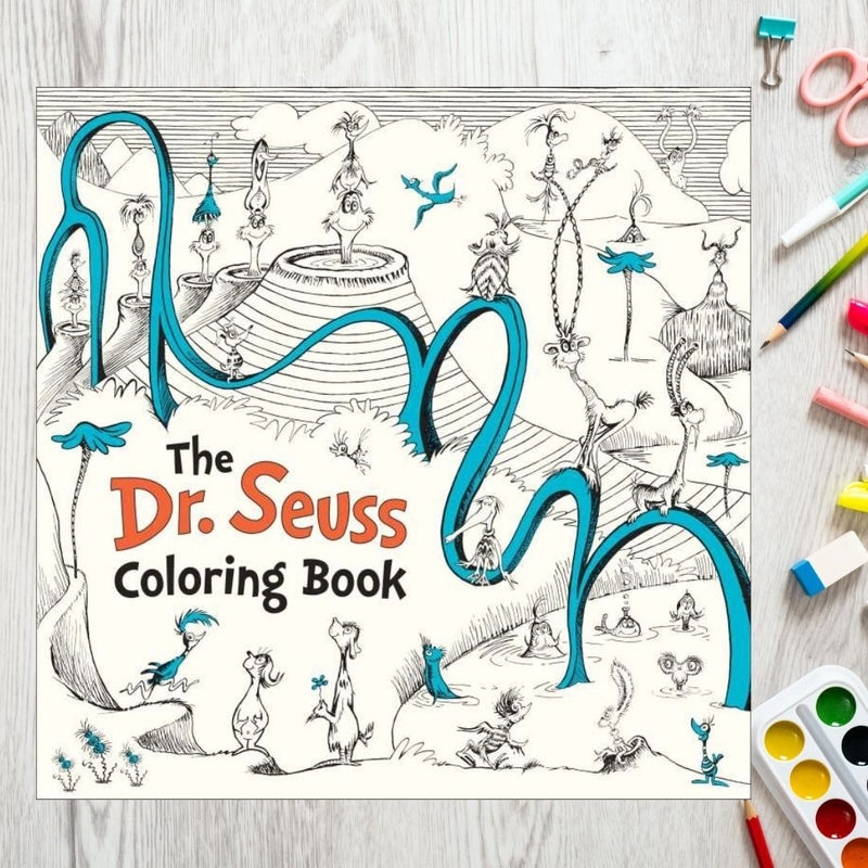 "The Dr. Seuss Coloring Book" on a table with art supplies