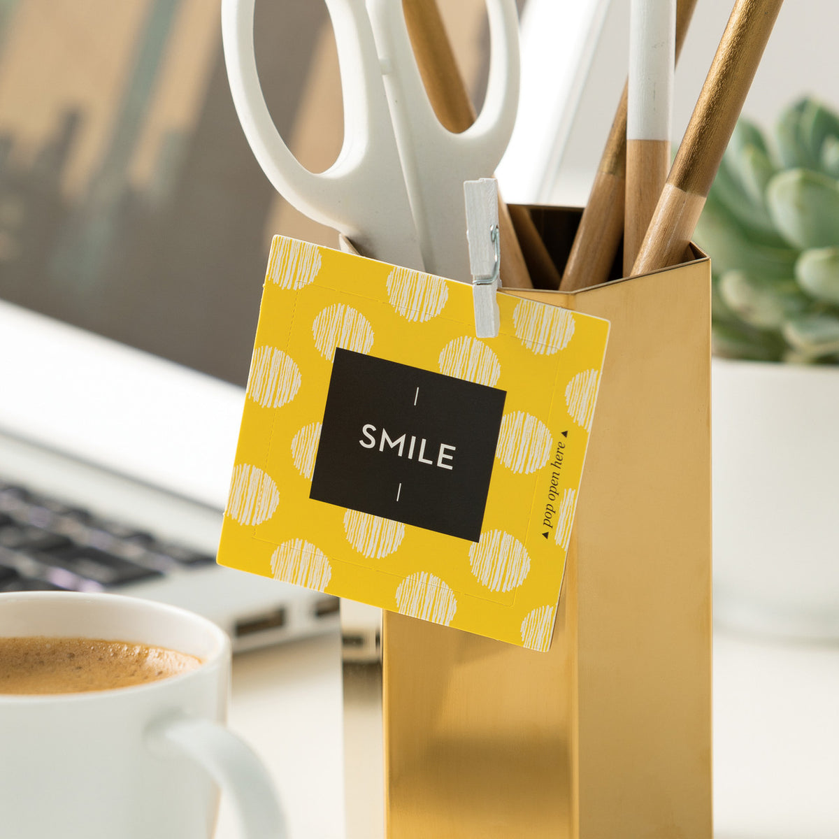 Smile card attached to pencil holder on a desk