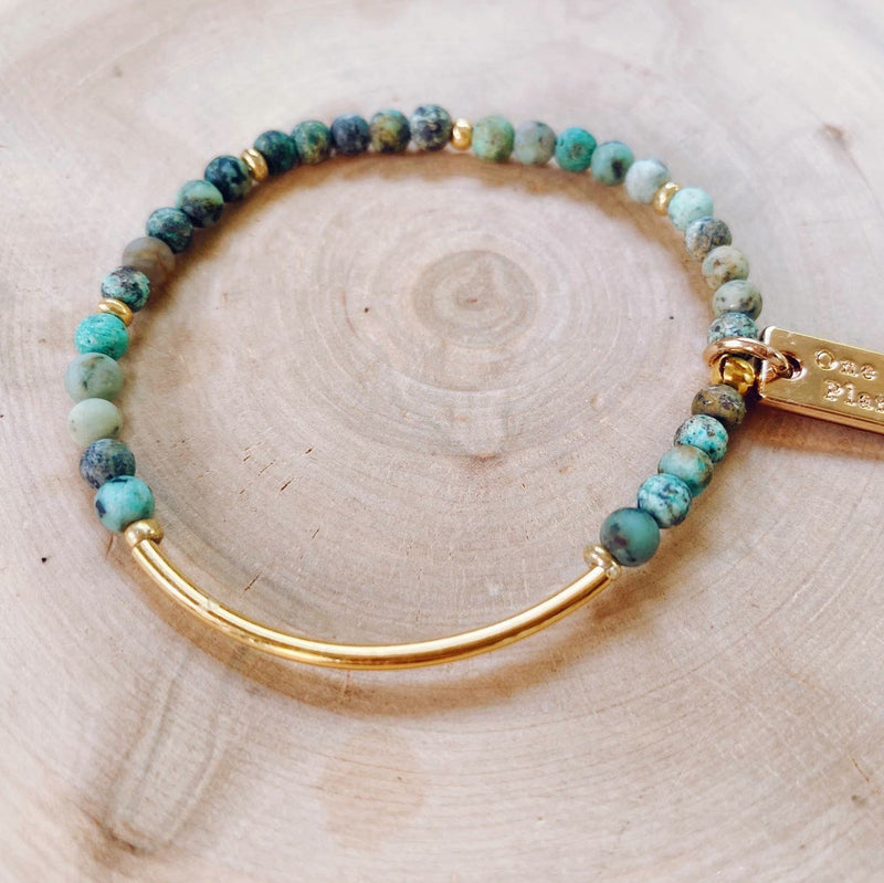 Bracelet with tiny green toned African Turquoise beads and a gold band