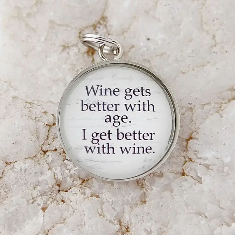 Round white necklace pendant that reads "Wine gets better with age. I get better with wine."