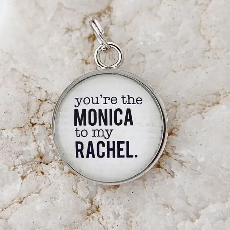 Round white pendant that reads, "you're the MONICA to my RACHEL." The edge of the pendant is silver.